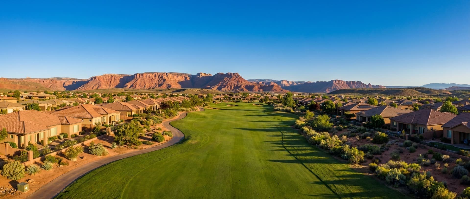 Golf fairways beneath red mesas at Mesquite, Nevada — representative imagery of the Virgin Valley